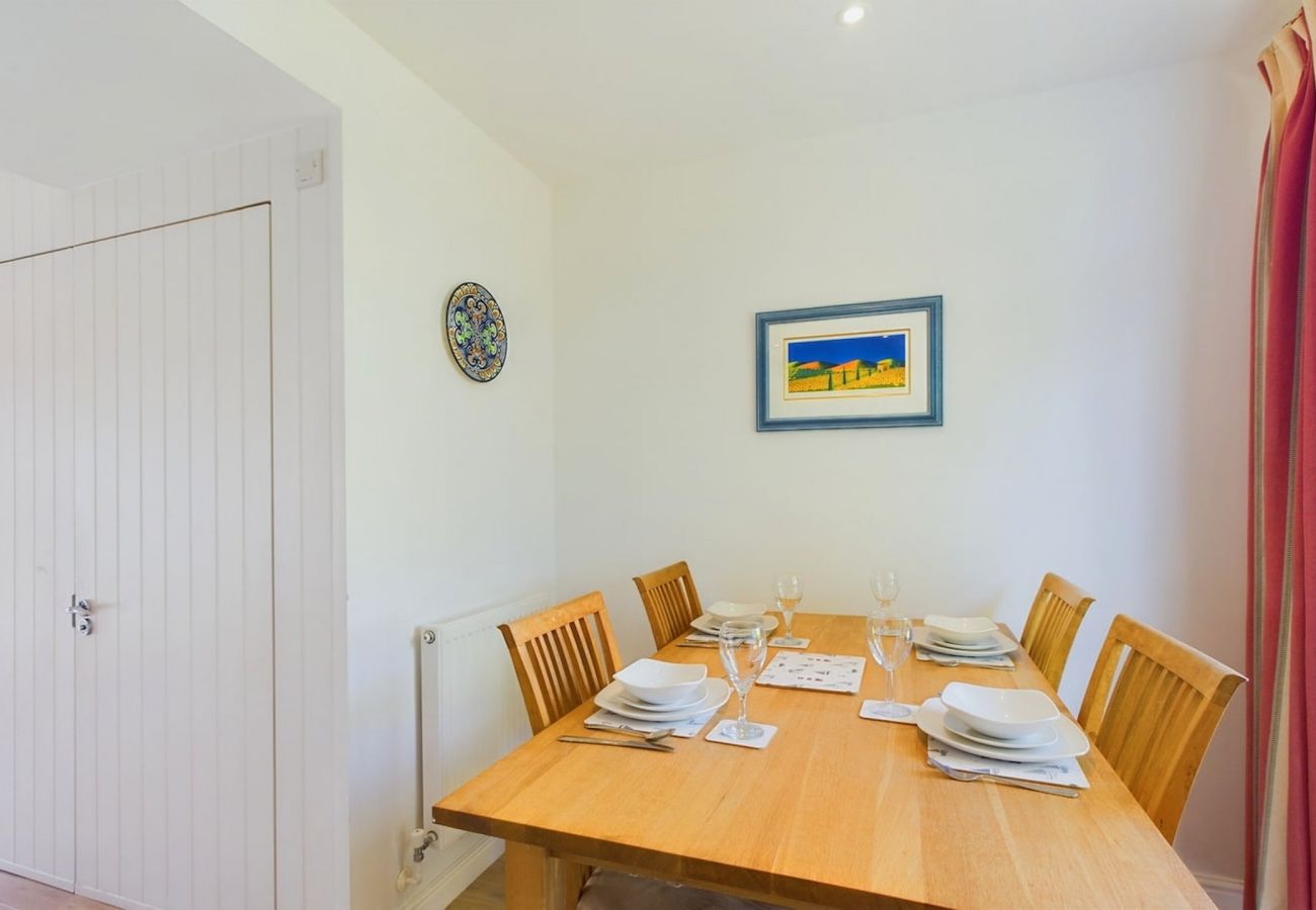 Dining area set for 4 guests at Isle of Wight Family-friendly Cottage in West Bay 