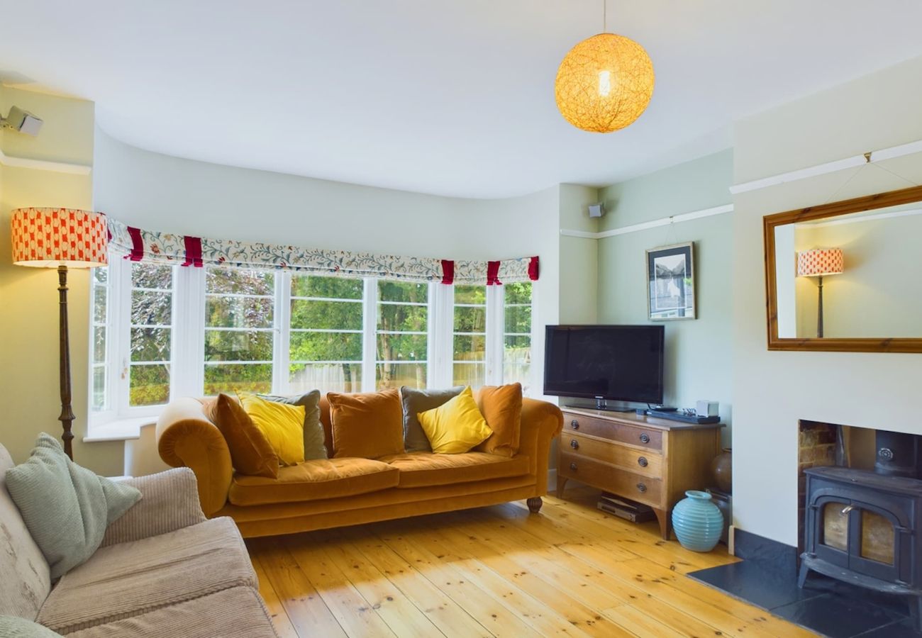 Coastal retreat with cosy lounge featuring rustic fireplace at The Timbers, Seaview Holiday Home, Isle of Wight