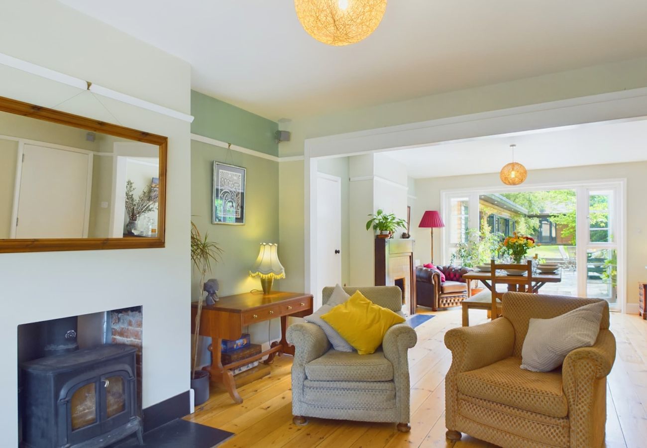Cosy open-plan sitting and dining room with plush armchairs for relaxing at The Timbers, Isle of Wight Coastal Retreat