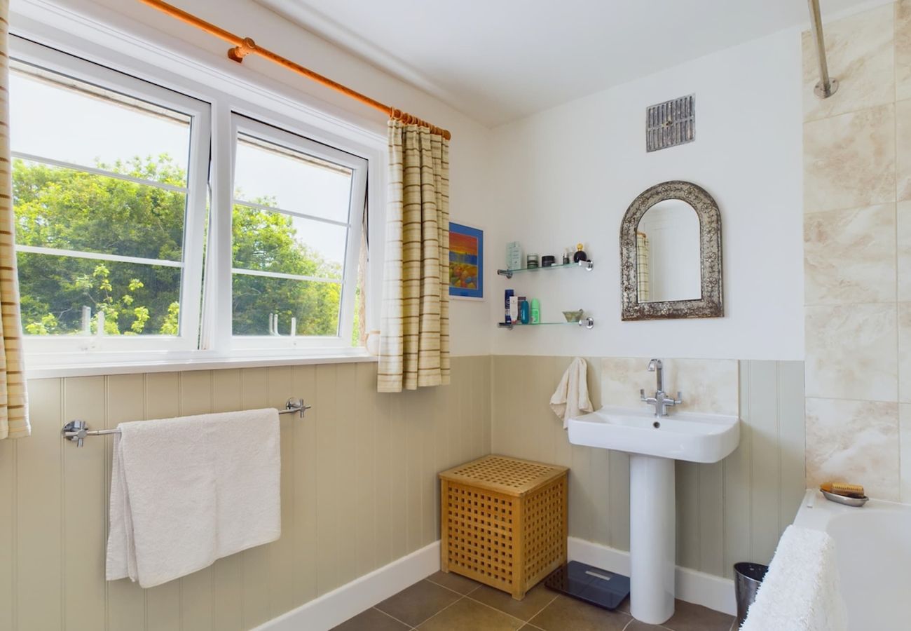 A luxurious bathroom equipped with a shower over the bath at The Timbers, Seaview Holiday Home